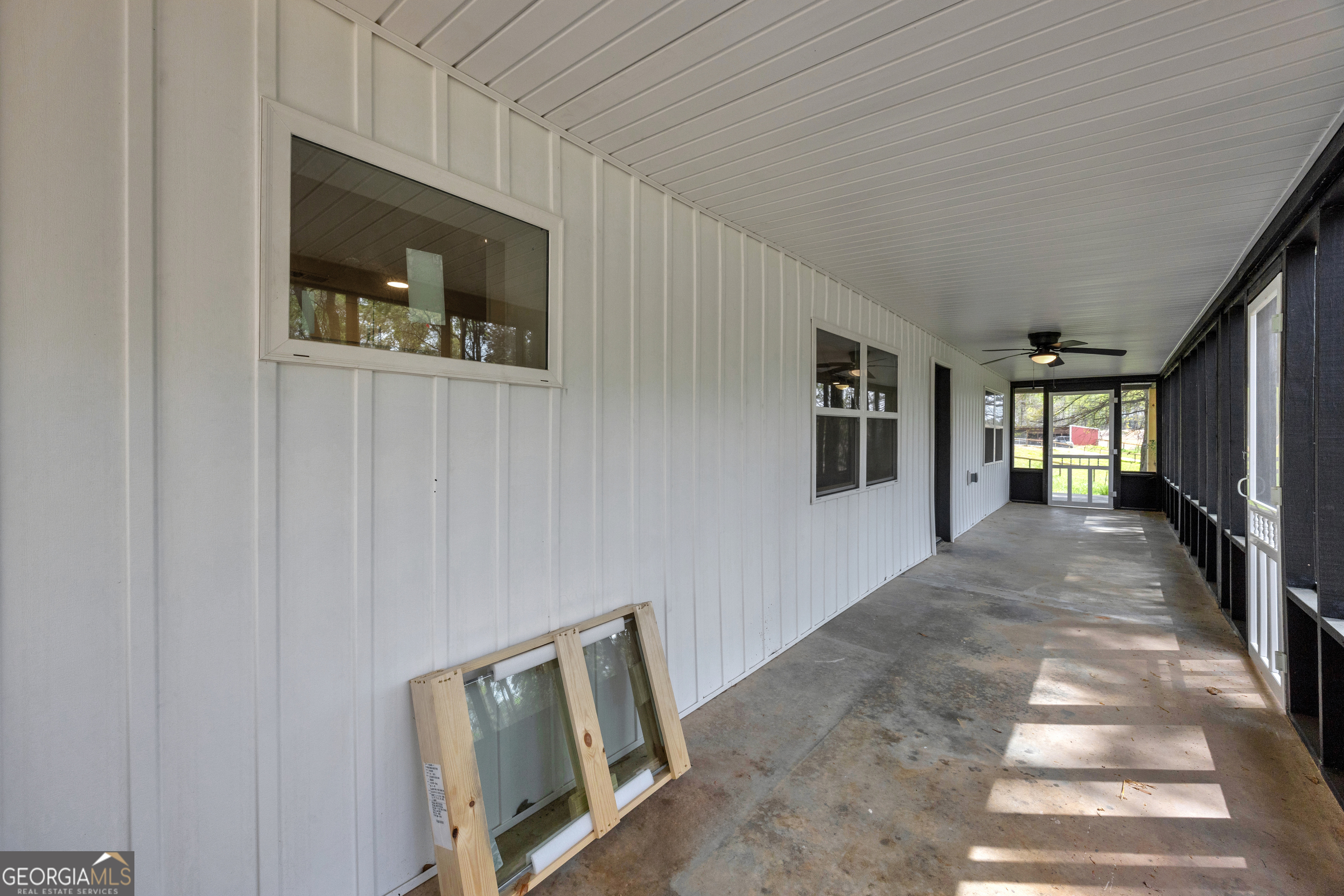8606 Holly Springs Road Maysville, GA 30558 - Photo 26 of 74 a view of a hallway with wooden floor and windows
