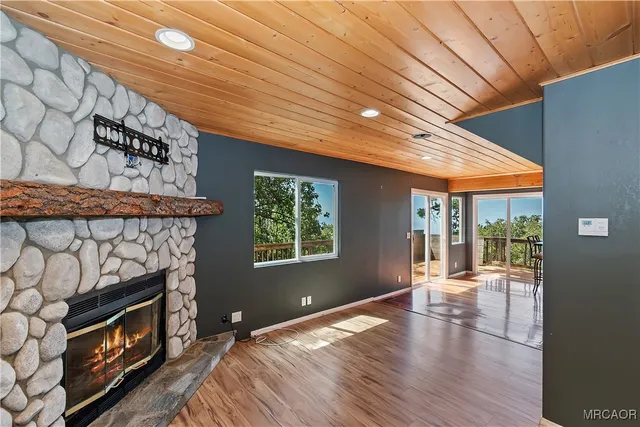 a kitchen with stainless steel appliances granite countertop wooden floors a stove and white cabinets