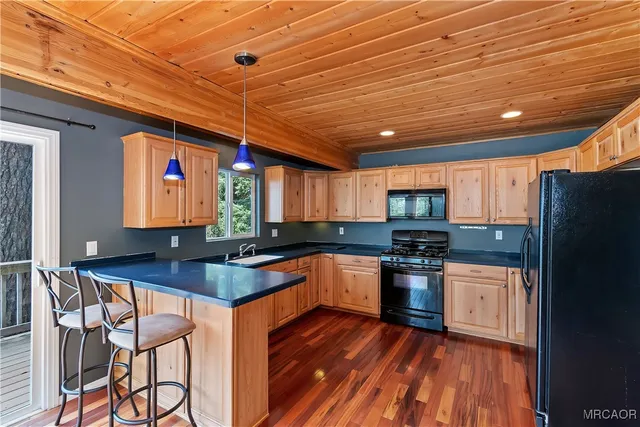 a kitchen with stainless steel appliances granite countertop a refrigerator stove and sink