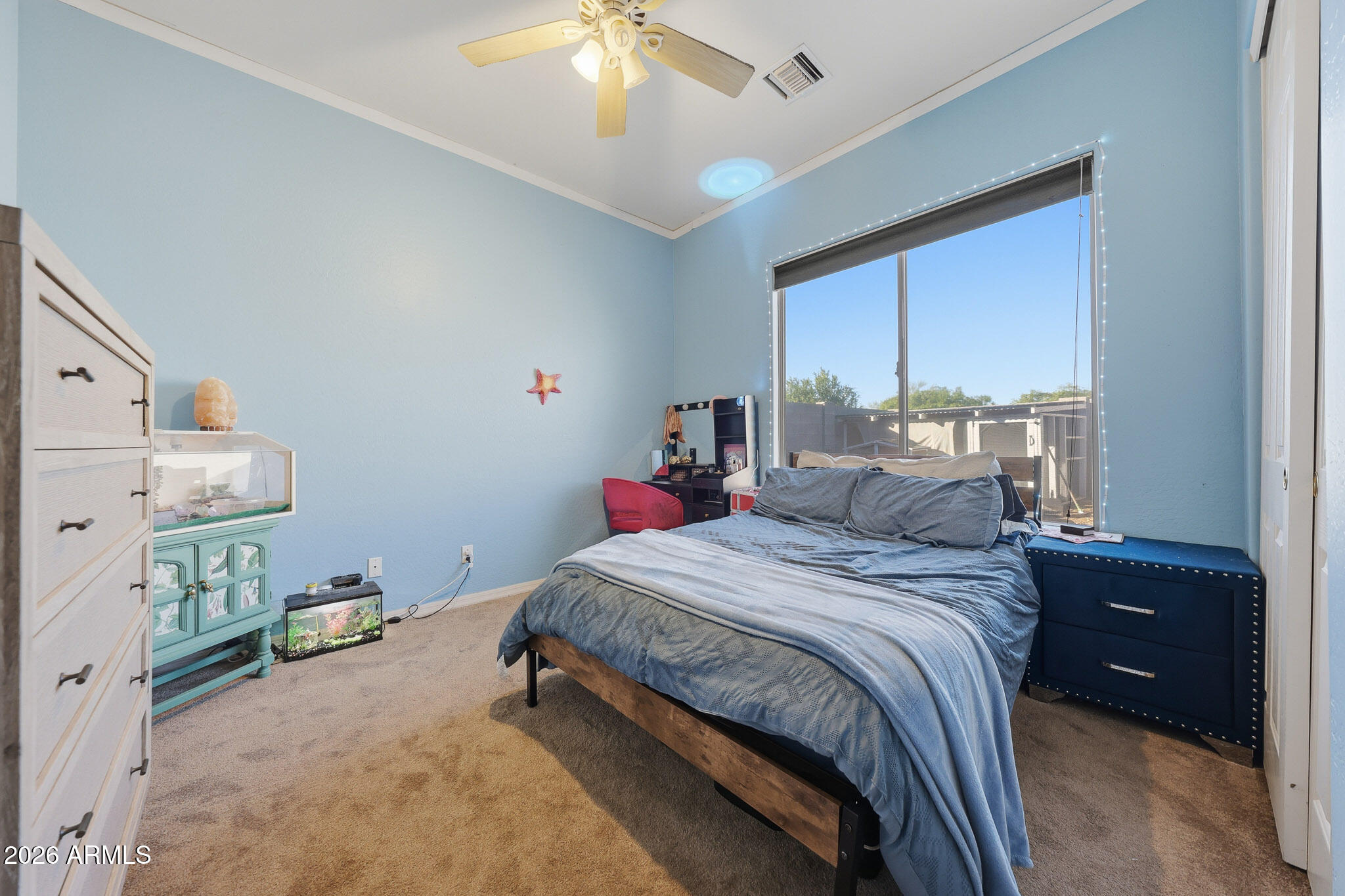 23024 West Sierra Ridge Way Wittmann, AZ 85361 - Photo 15 of 99 a bedroom with a bed and a chandelier