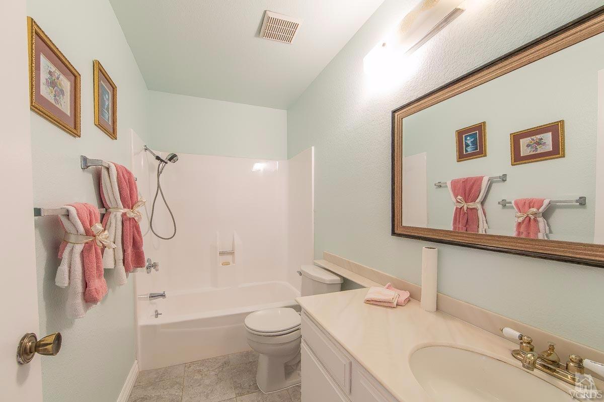 6128 Al Way Simi Valley, CA 93063 - Photo 15 of 27 a bathroom with a granite countertop sink mirror vanity and toilet