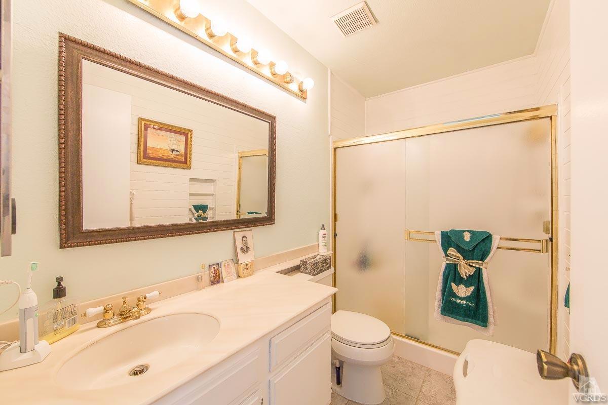 6128 Al Way Simi Valley, CA 93063 - Photo 18 of 27 a bathroom with a sink mirror vanity and toilet