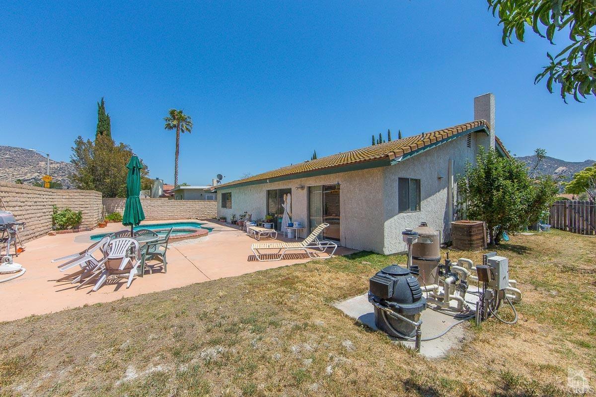 6128 Al Way Simi Valley, CA 93063 - Photo 25 of 27 a view of a backyard with table and chairs under an umbrella