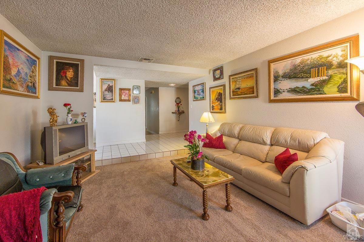 6128 Al Way Simi Valley, CA 93063 - Photo 4 of 27 a living room with furniture a couch and a flat screen tv