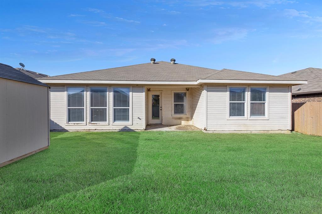 605 Clearbrook Street Azle, TX 76020 - Photo 29 of 33 Expansive green lawn with a detached storage shed