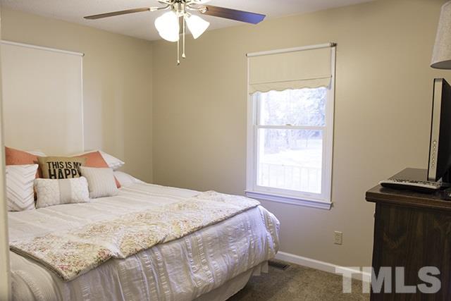 860 Reuben Allen Road Roxboro, NC 27574 - Photo 11 of 17 a bedroom with a bed and a window