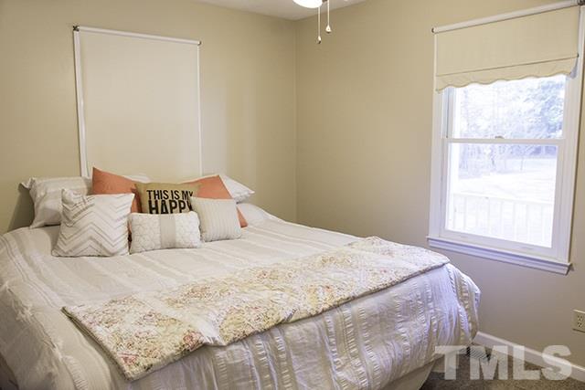 860 Reuben Allen Road Roxboro, NC 27574 - Photo 12 of 17 a bedroom with a bed and a window