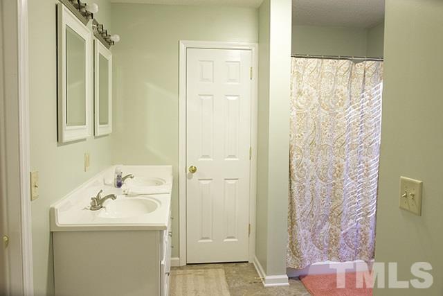 860 Reuben Allen Road Roxboro, NC 27574 - Photo 13 of 17 a bathroom with a sink and mirror with shower