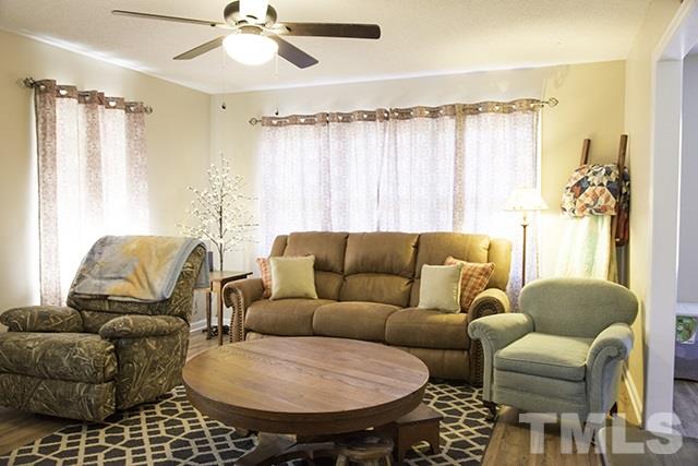 860 Reuben Allen Road Roxboro, NC 27574 - Photo 4 of 17 a living room with furniture and a chandelier