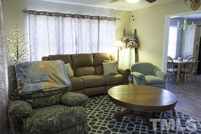 860 Reuben Allen Road Roxboro, NC 27574 - Photo 5 of 17 a living room with furniture and a chandelier