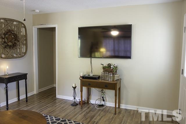 860 Reuben Allen Road Roxboro, NC 27574 - Photo 6 of 17 a view of a workspace with furniture and wooden floor