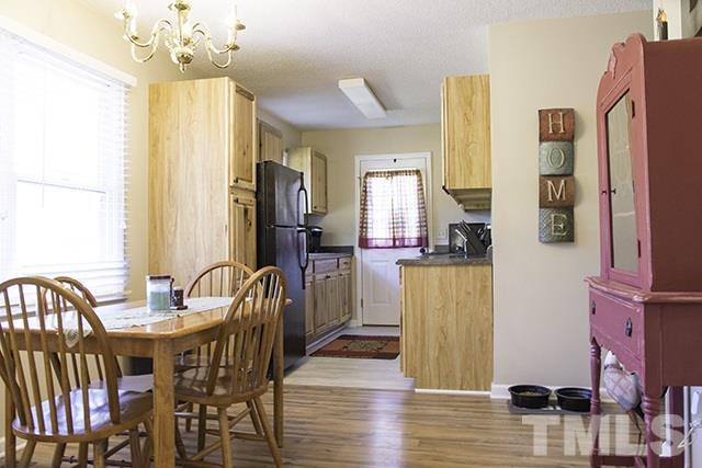 860 Reuben Allen Road Roxboro, NC 27574 - Photo 8 of 17 a dining room with furniture and wooden floor