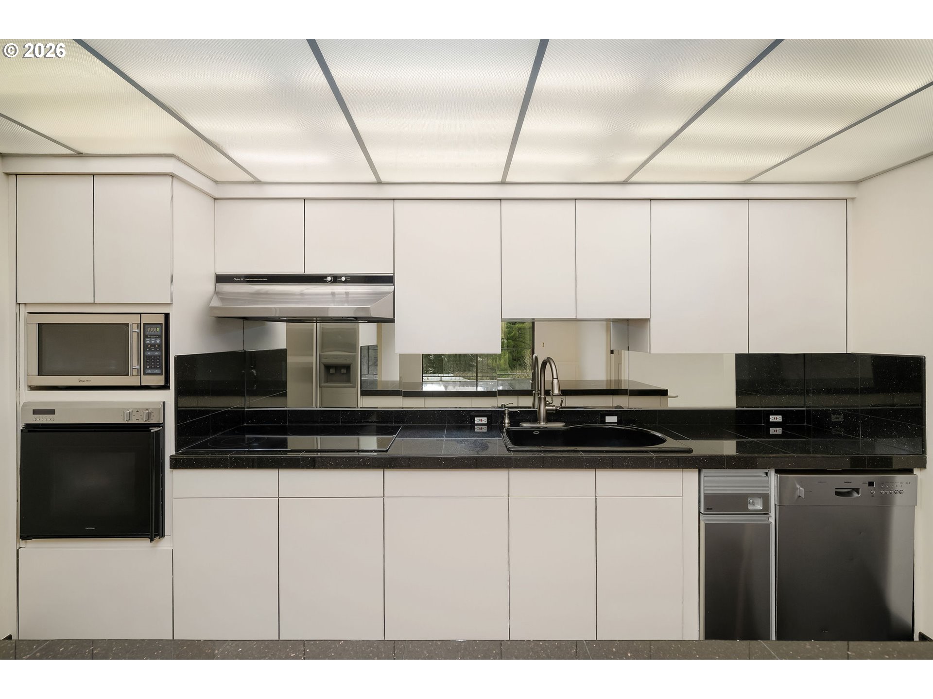 2309 Southwest 1st Avenue, Unit 741 Portland, OR 97201 - Photo 15 of 36 a kitchen with stainless steel appliances a stove a sink and a microwave