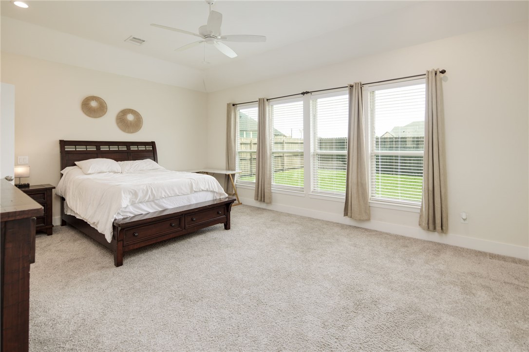 4302 Appalachian Trail Bryan, TX 77802 - Photo 11 of 25 a bed sitting in a spacious bedroom next to a window