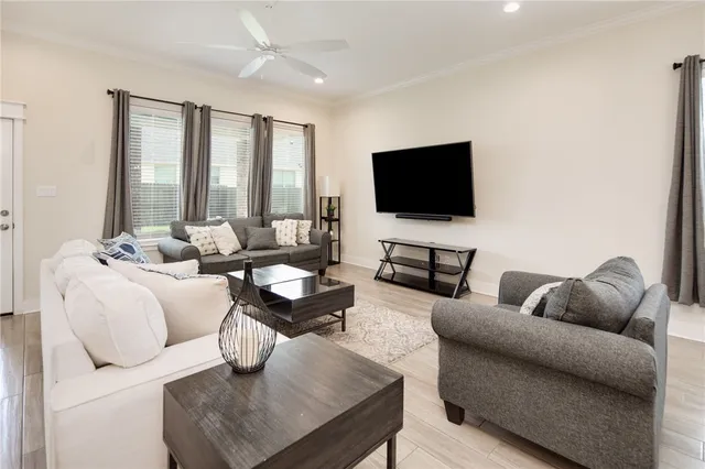 a living room with furniture and a flat screen tv
