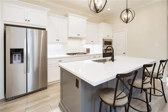 a kitchen with a stove a refrigerator and wooden floor