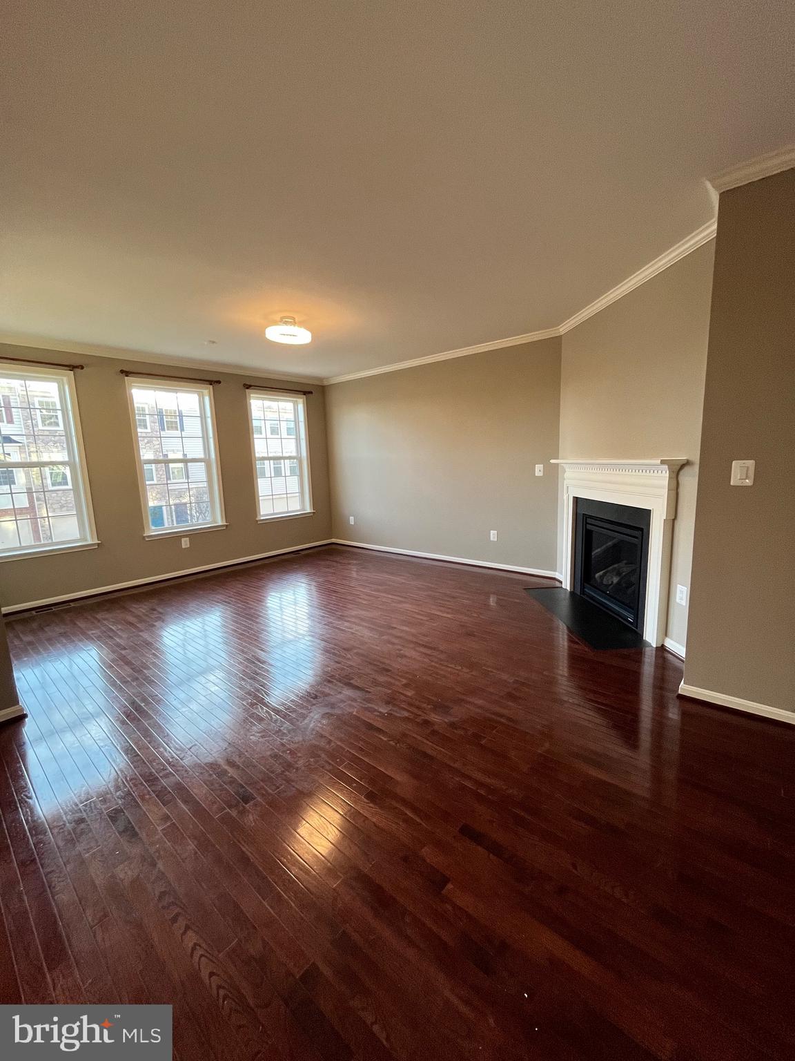42253 Dean Chapel Square Chantilly, VA 20152 - Photo 4 of 24 a view of a livingroom with wooden floor and a fireplace