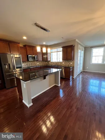 a kitchen with stainless steel appliances granite countertop a stove and cabinets
