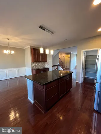 a kitchen with stainless steel appliances granite countertop a stove and a refrigerator