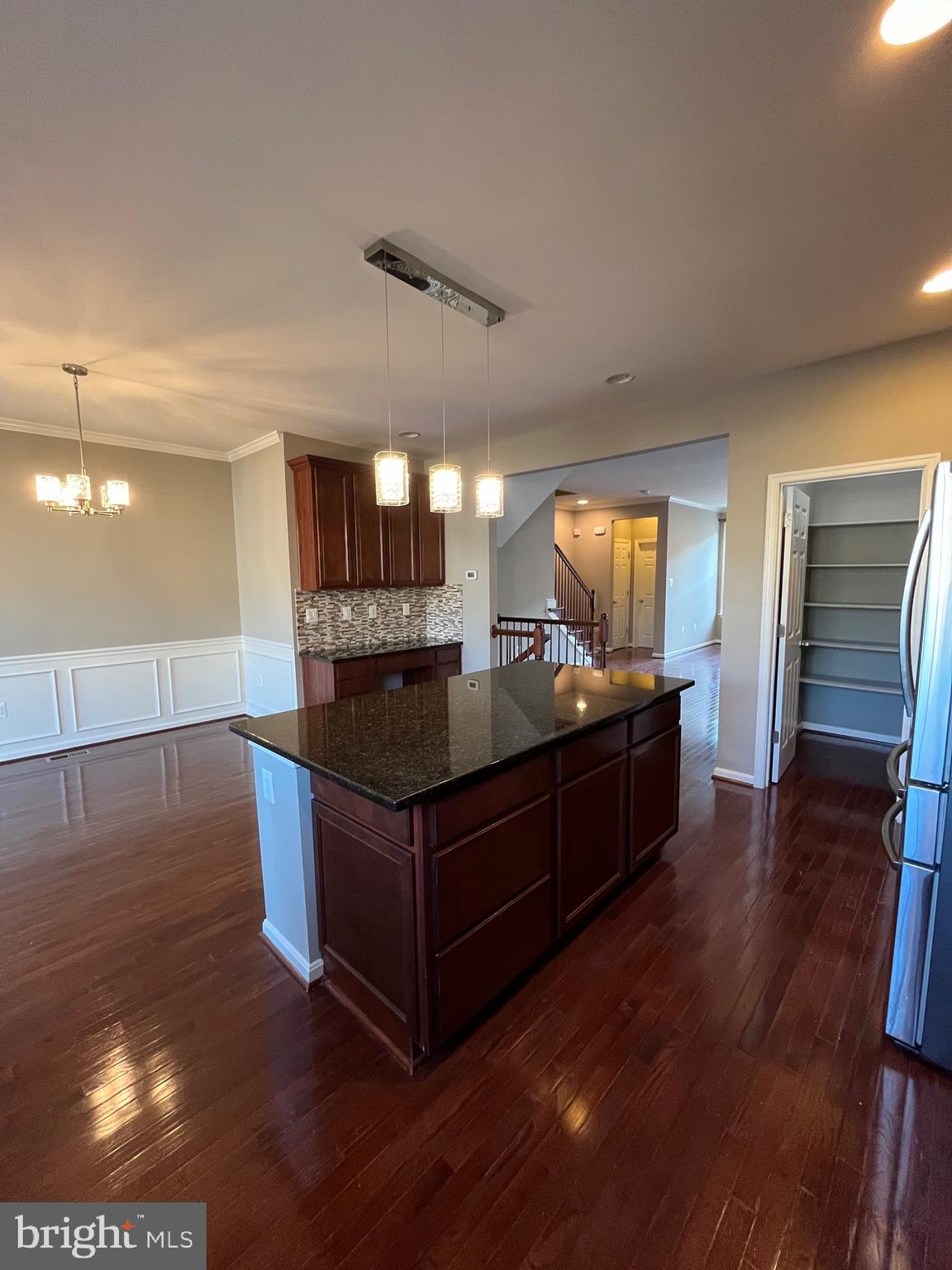 42253 Dean Chapel Square Chantilly, VA 20152 - Photo 6 of 24 a kitchen with stainless steel appliances granite countertop a stove and a refrigerator