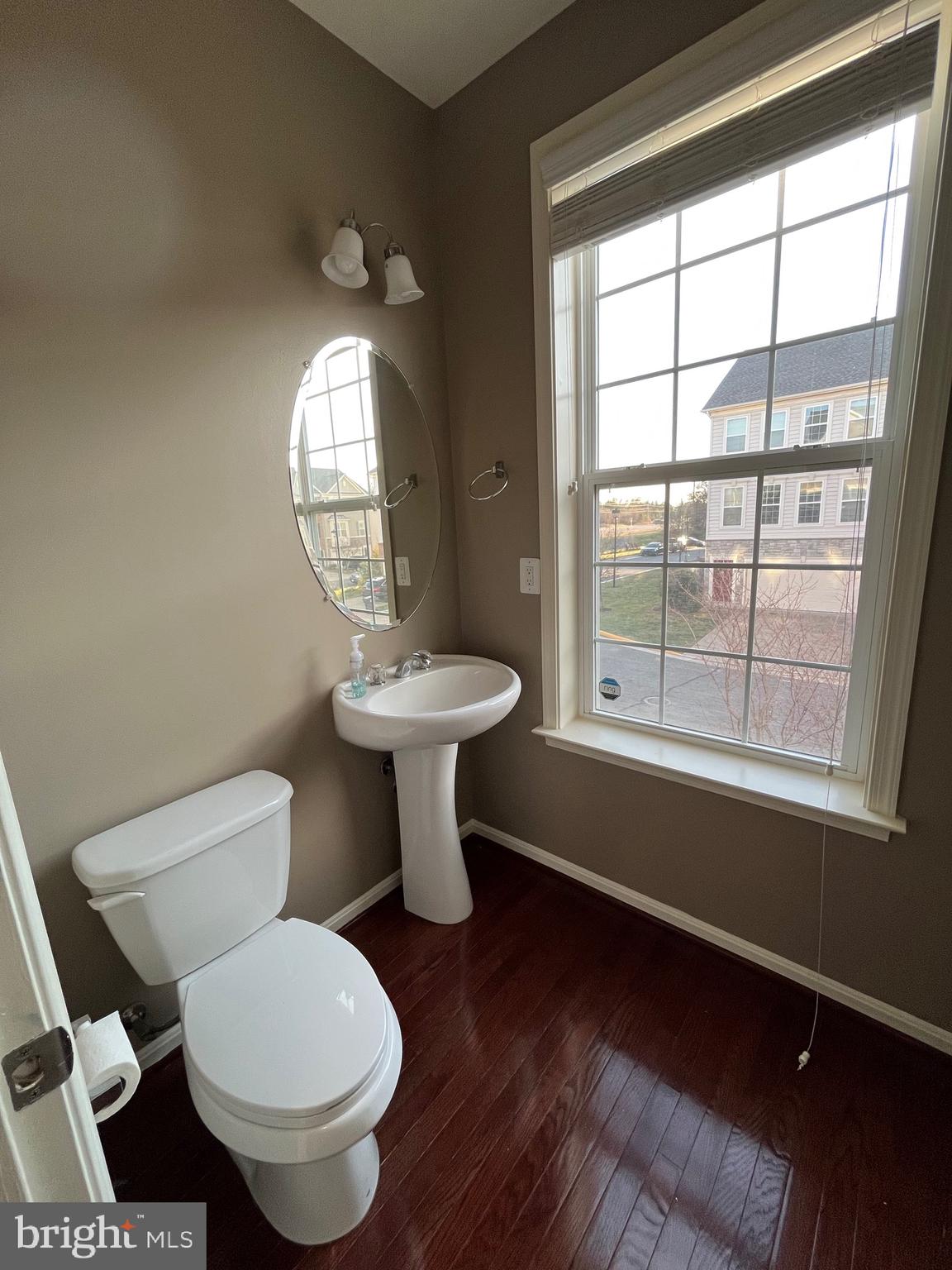42253 Dean Chapel Square Chantilly, VA 20152 - Photo 7 of 24 a bathroom with a toilet sink a mirror and a window