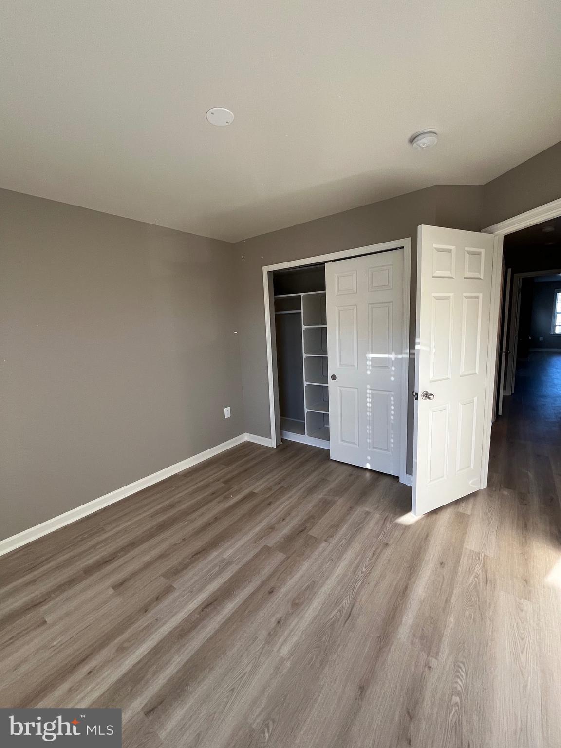 42253 Dean Chapel Square Chantilly, VA 20152 - Photo 8 of 24 a view of an empty room with wooden floor and closet