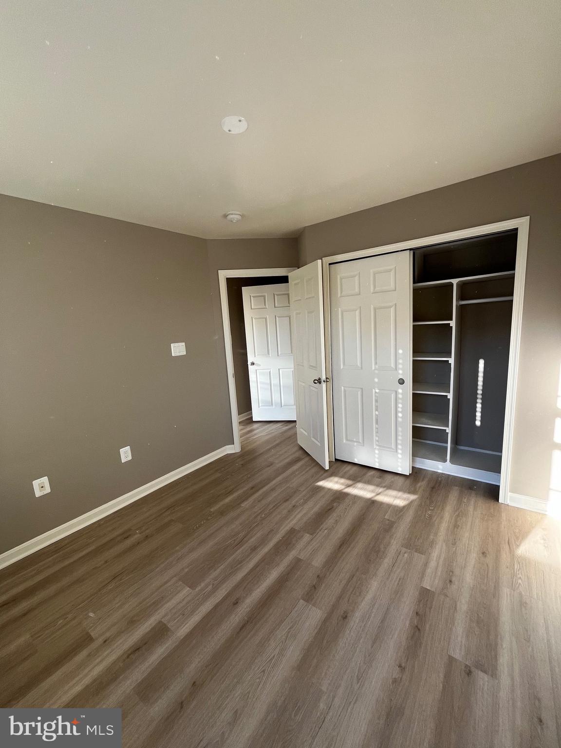 42253 Dean Chapel Square Chantilly, VA 20152 - Photo 9 of 24 a view of an empty room with wooden floor and closet