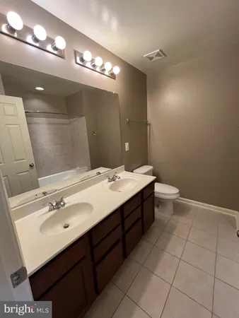 a bathroom with a sink vanity and a mirror