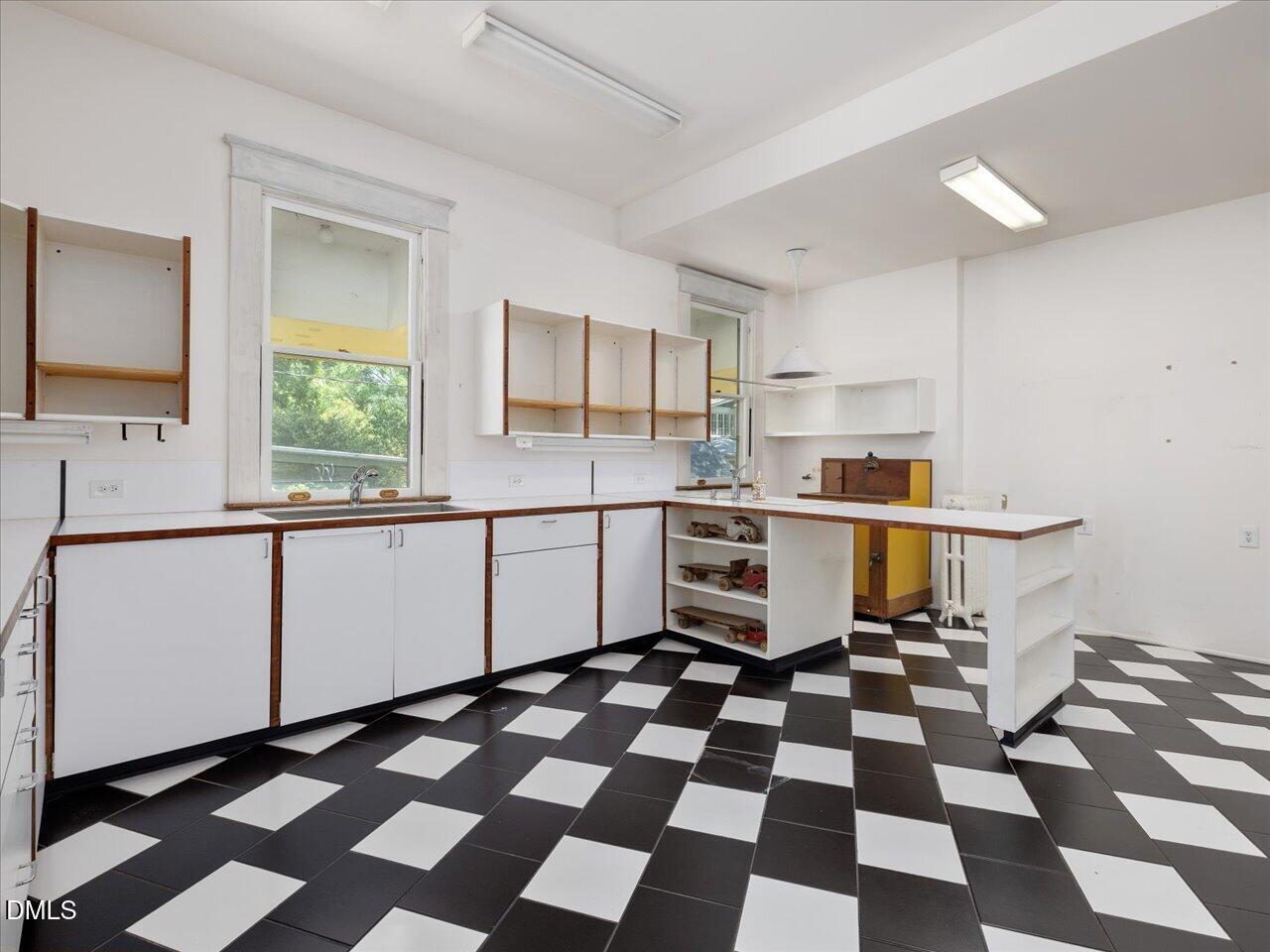 215 Hillcrest Road Raleigh, NC 27605 - Photo 37 of 97 a kitchen with a stove a sink and a window