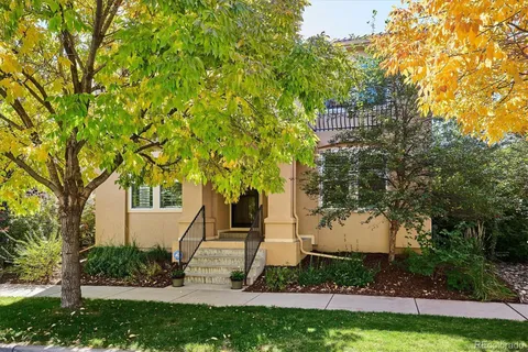 a front view of a house with a yard and trees