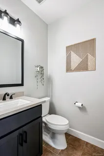 a bathroom with a sink a toilet and mirror