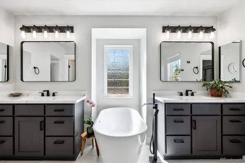 a bathroom with a double vanity sink and a mirror
