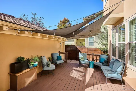 a view of a chairs and table in the balcony