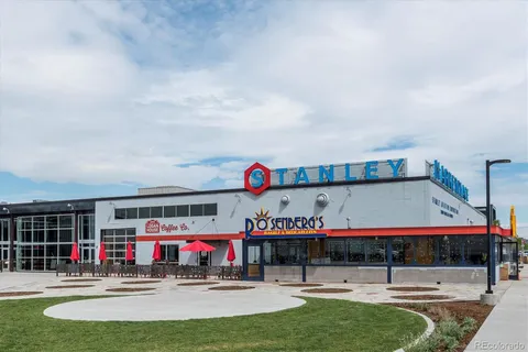 a sign board with buildings in the background