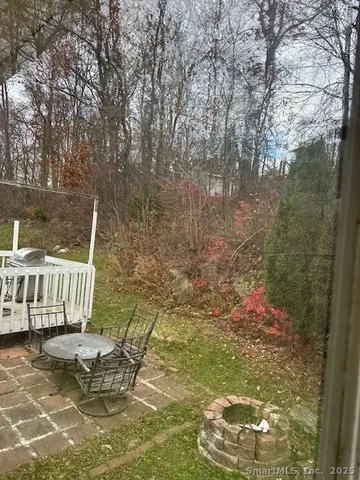 a view of swimming pool with lawn chairs and wooden fence