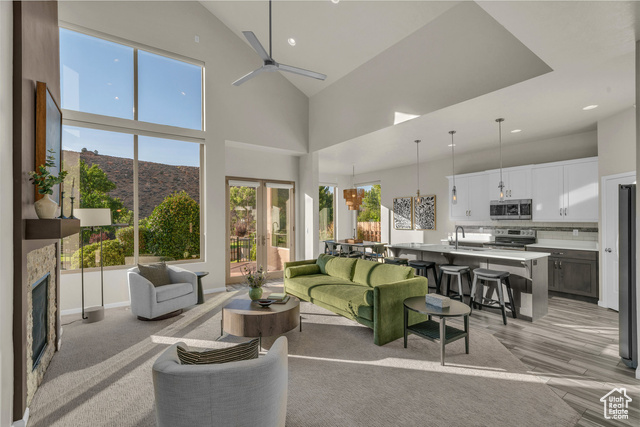 101 Chuckwalla Lane Springdale, UT 84767 - Photo 19 of 51 Living room with high vaulted ceiling, recessed lighting, a fireplace, french doors, and a mountain view