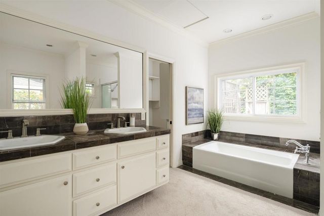 a bathroom with a bathtub and a shower