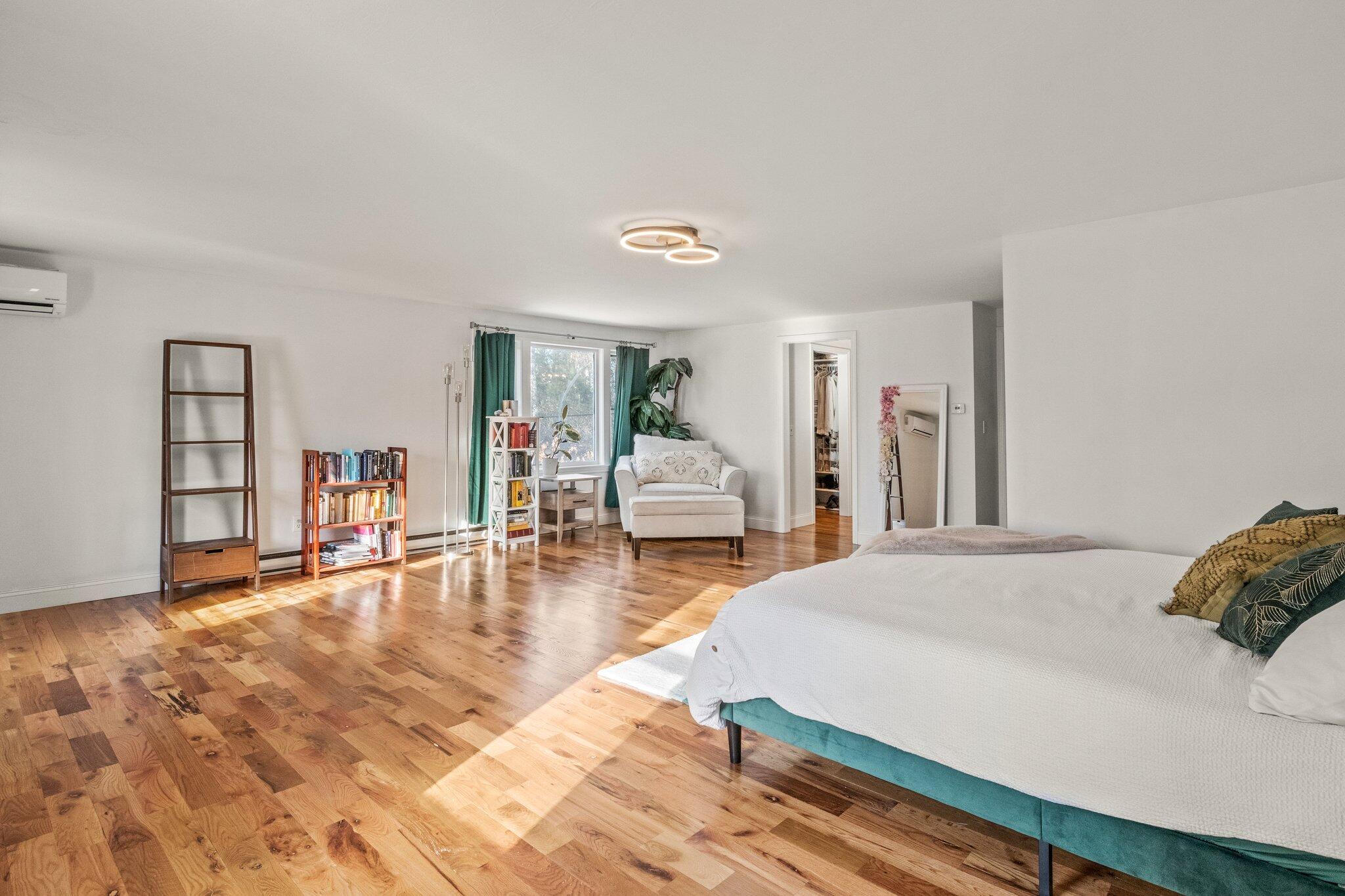9 Deacons Path Sandwich, MA 02563 - Photo 12 of 41 a spacious bedroom with a bed and wooden floor