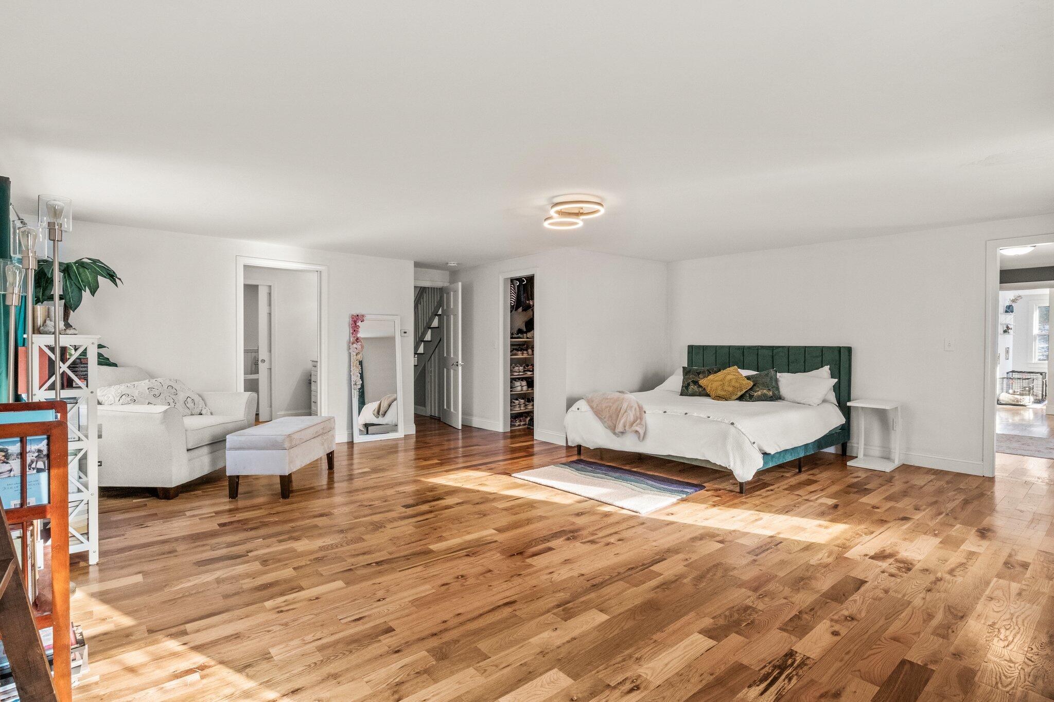 9 Deacons Path Sandwich, MA 02563 - Photo 13 of 41 a spacious bedroom with a bed a couch and a window