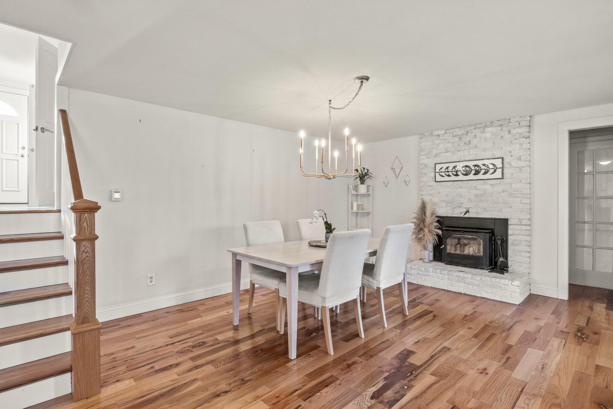 9 Deacons Path Sandwich, MA 02563 - Photo 16 of 41 a view of a dining room with furniture wooden floor and a fireplace