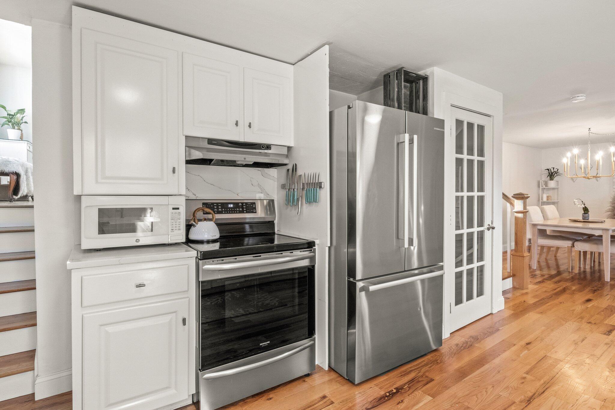 9 Deacons Path Sandwich, MA 02563 - Photo 20 of 41 a kitchen with cabinets and stainless steel appliances