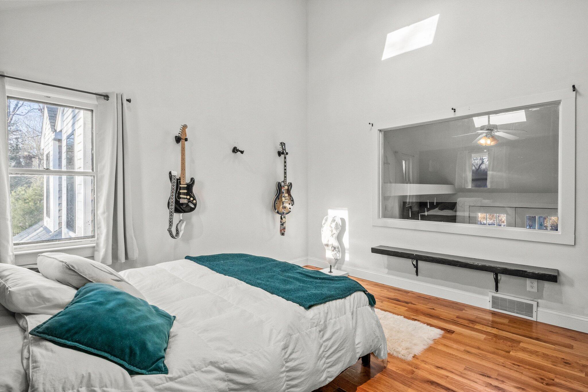 9 Deacons Path Sandwich, MA 02563 - Photo 33 of 41 a bedroom with a bed and a large window with wooden floor