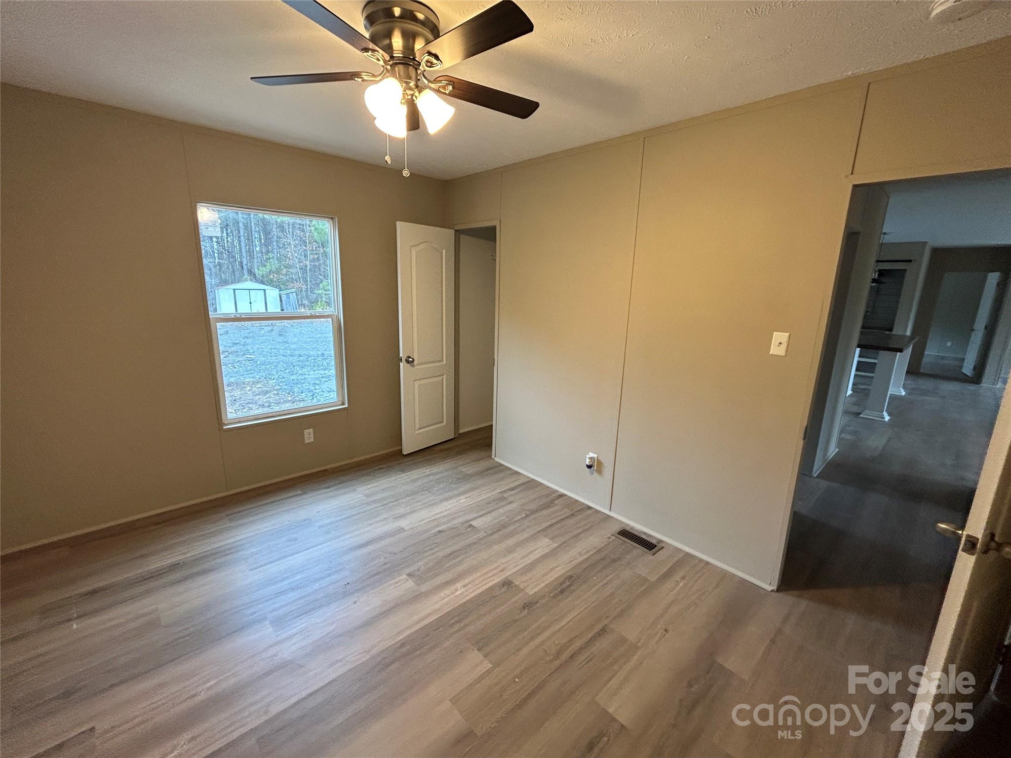 4765 Logging Road Lancaster, SC 29720 - Photo 11 of 19 a view of an empty room with wooden floor and a window