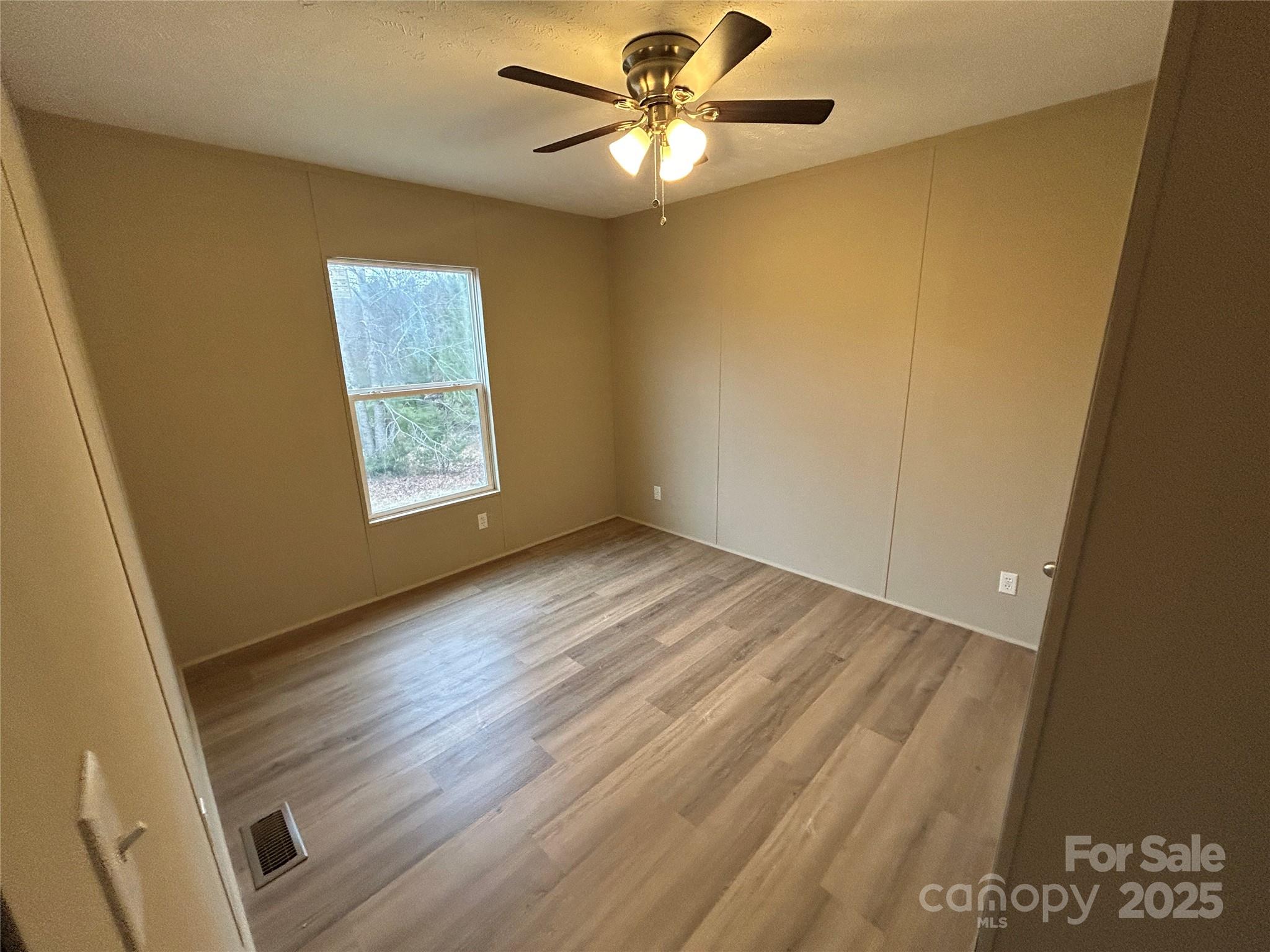 4765 Logging Road Lancaster, SC 29720 - Photo 12 of 19 a view of a room with wooden floor and a ceiling fan