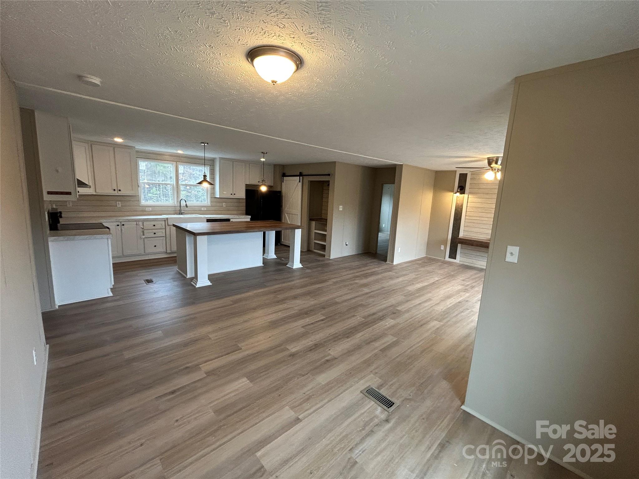 4765 Logging Road Lancaster, SC 29720 - Photo 5 of 19 a view of a kitchen with cabinets and wooden floor