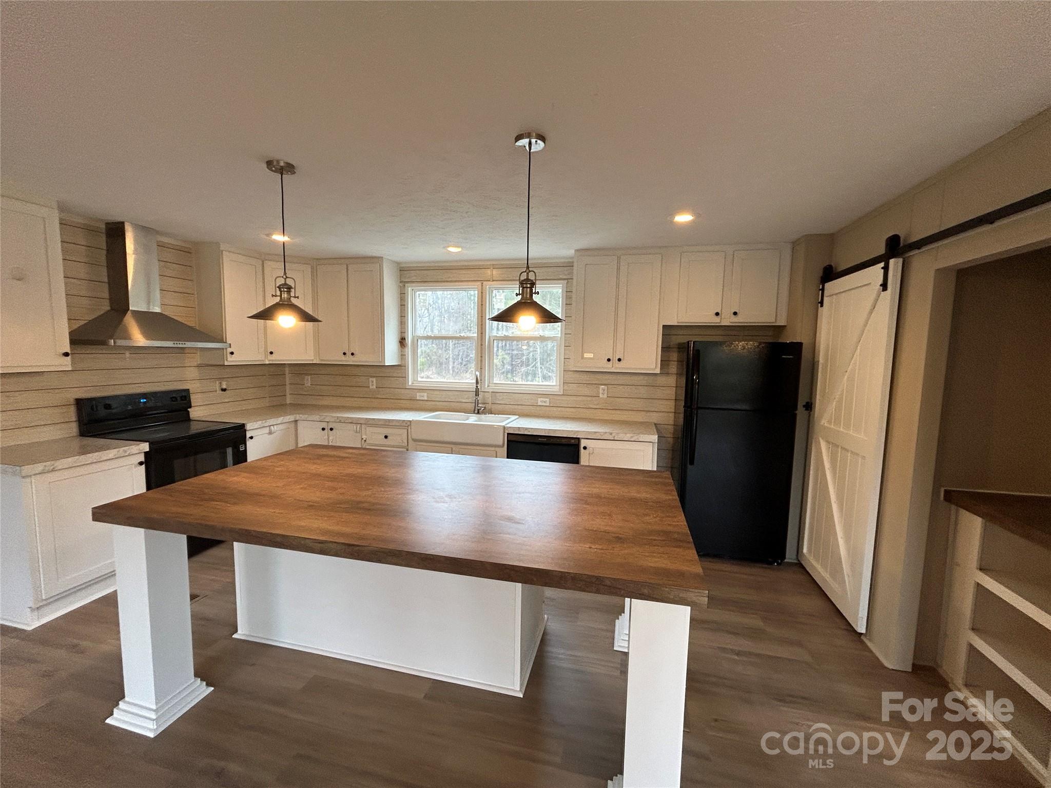 4765 Logging Road Lancaster, SC 29720 - Photo 7 of 19 a kitchen with stainless steel appliances a refrigerator a sink a stove a dining table and chairs