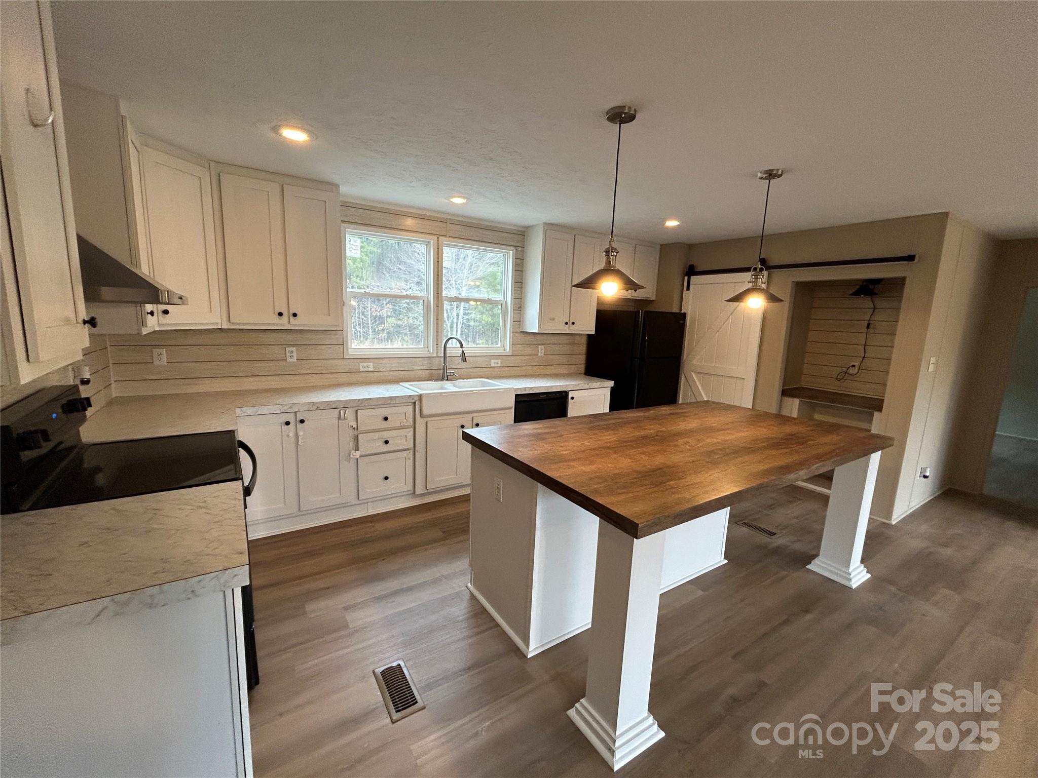 4765 Logging Road Lancaster, SC 29720 - Photo 8 of 19 a kitchen with a table chairs sink and cabinets