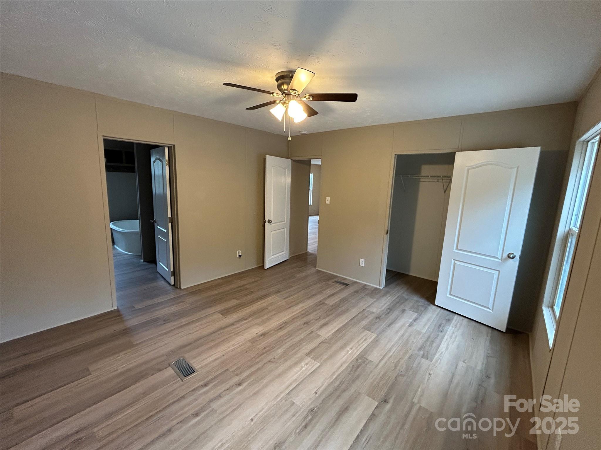4765 Logging Road Lancaster, SC 29720 - Photo 9 of 19 a view of a livingroom with wooden floor and a ceiling fan