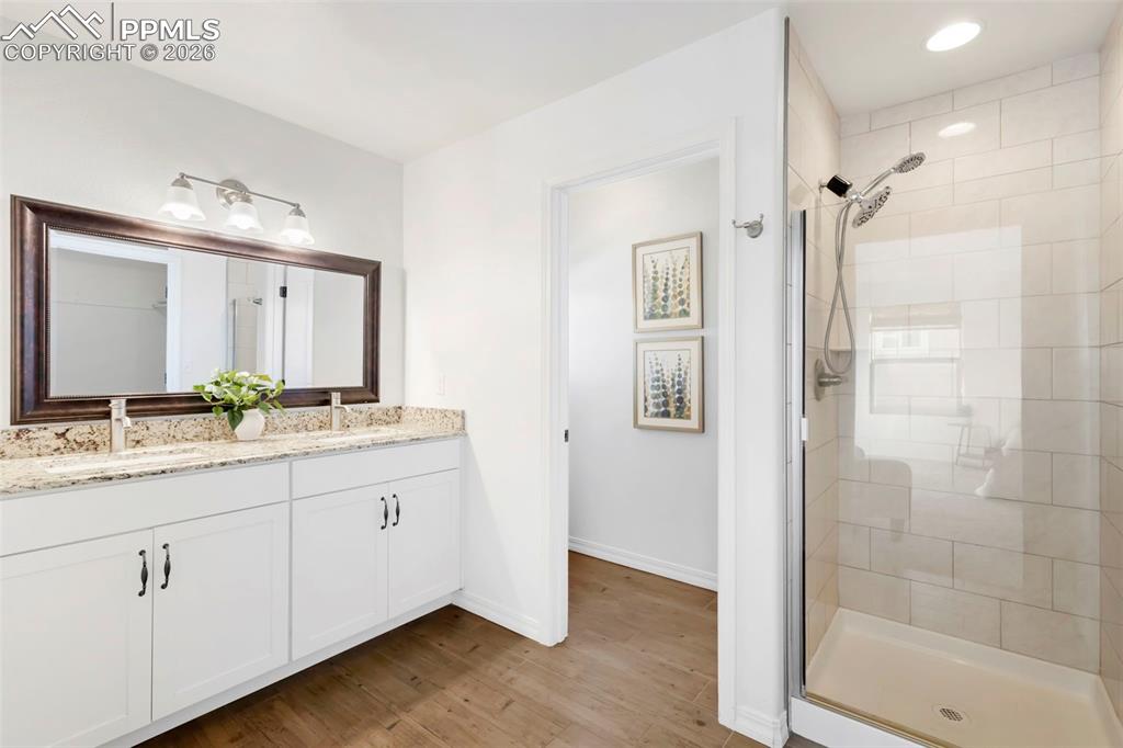 6528 Watusi Road Peyton, CO 80831 - Photo 16 of 27 a bathroom with a granite countertop sink mirror and double