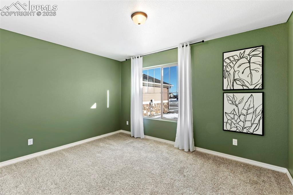 6528 Watusi Road Peyton, CO 80831 - Photo 21 of 27 an empty room with painting and stairs